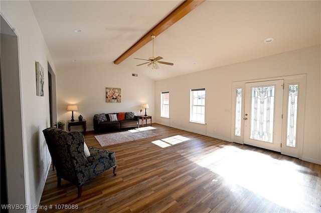 living room featuring vaulted ceiling with beams, dark hardwood / wood-style floors, ceiling fan, and a healthy amount of sunlight