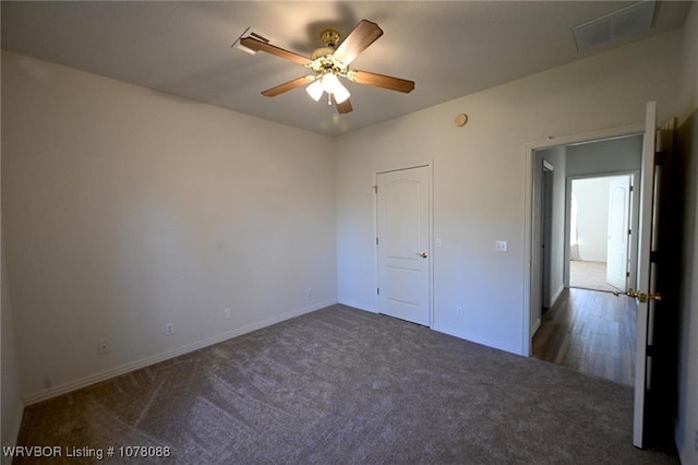 unfurnished bedroom featuring ceiling fan and dark carpet