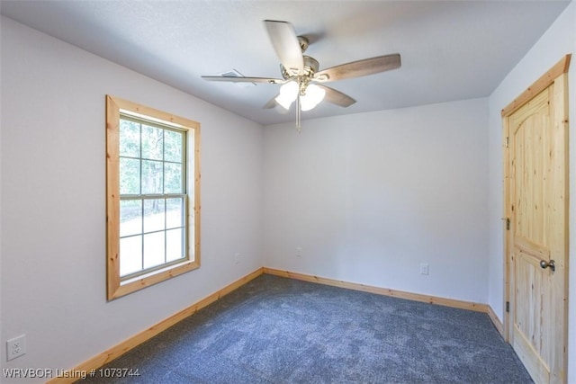 spare room featuring ceiling fan and carpet floors