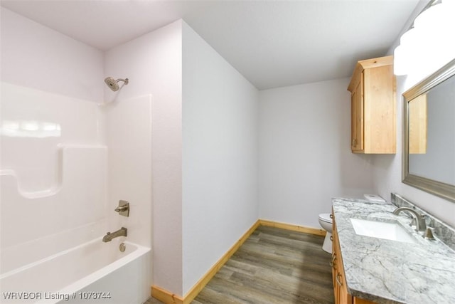 full bathroom with shower / bathing tub combination, vanity, toilet, and hardwood / wood-style floors