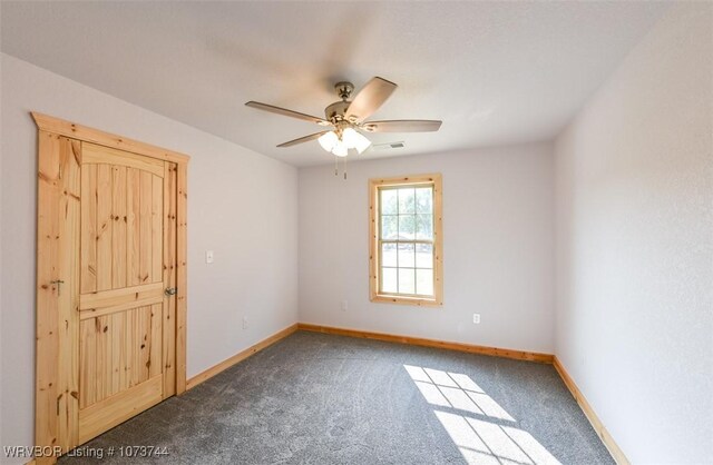 empty room with carpet flooring and ceiling fan