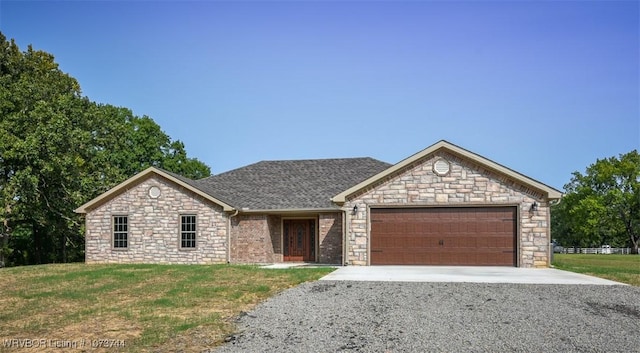 ranch-style home featuring a garage and a front lawn