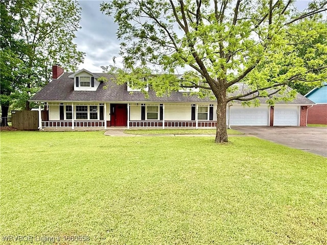 view of front facade with a porch, an attached garage, driveway, and a front lawn