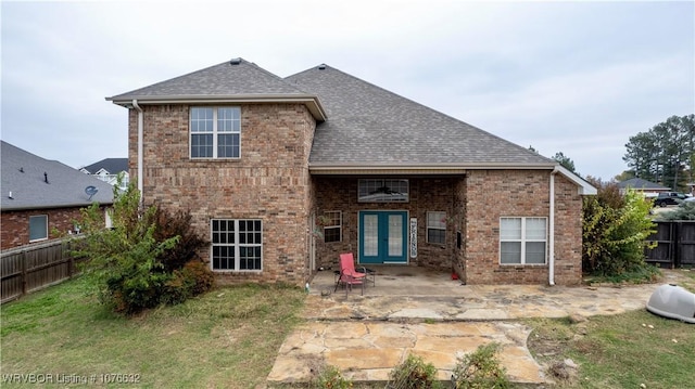 rear view of house featuring a yard, a patio area, and french doors