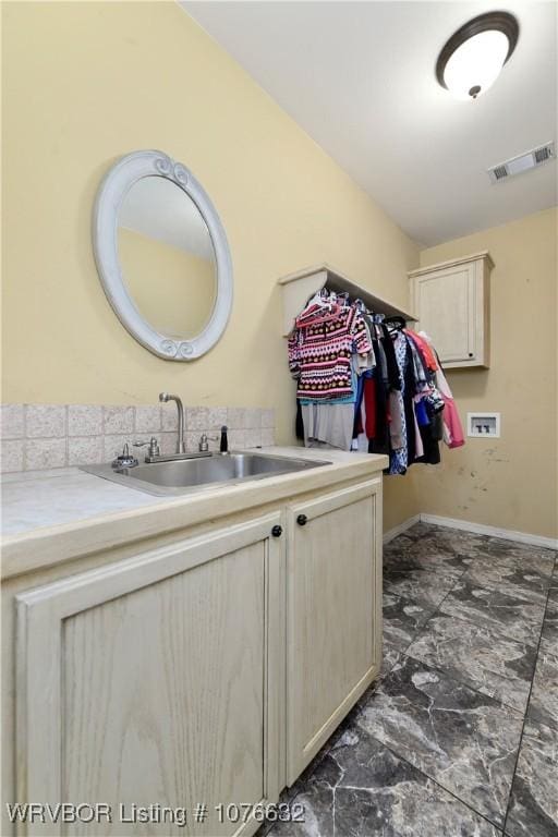 laundry area featuring hookup for a washing machine, cabinets, and sink