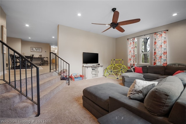 carpeted living room with ceiling fan