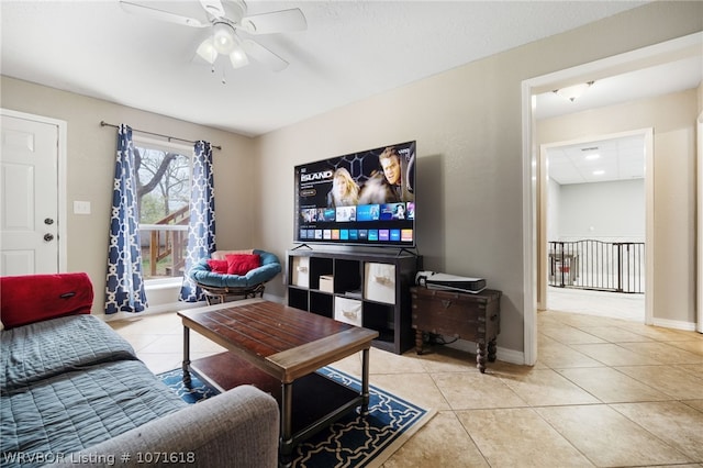 tiled living room featuring ceiling fan