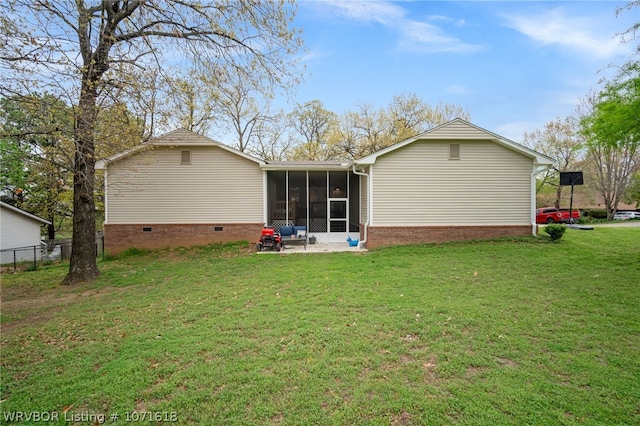 back of house featuring a lawn and a sunroom