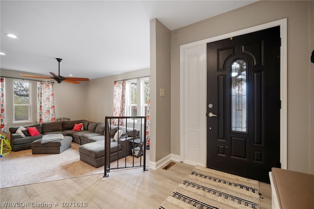 entrance foyer with ceiling fan and light hardwood / wood-style flooring