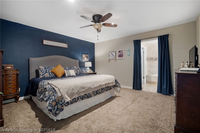 carpeted bedroom featuring ensuite bath and ceiling fan