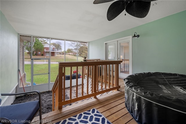 sunroom featuring ceiling fan