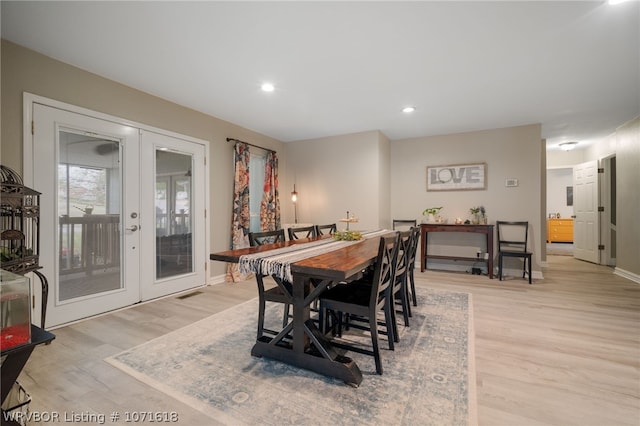 dining space featuring light hardwood / wood-style flooring and french doors