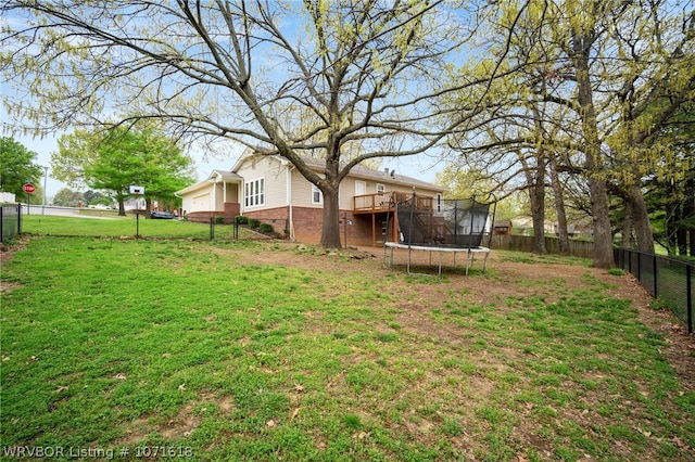 view of yard featuring a deck and a trampoline