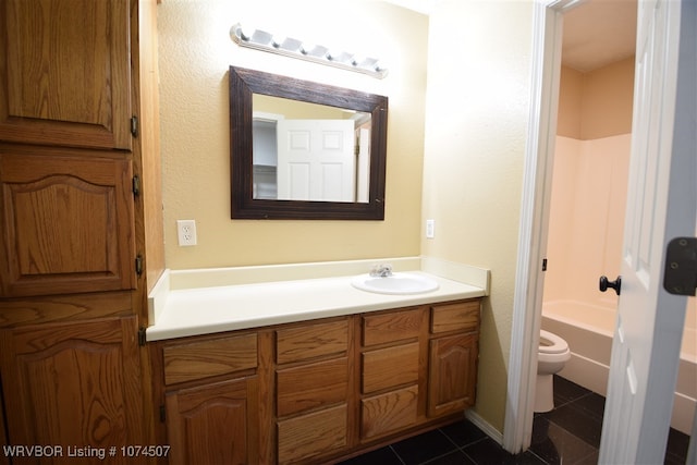 bathroom with tile patterned floors, vanity, and toilet