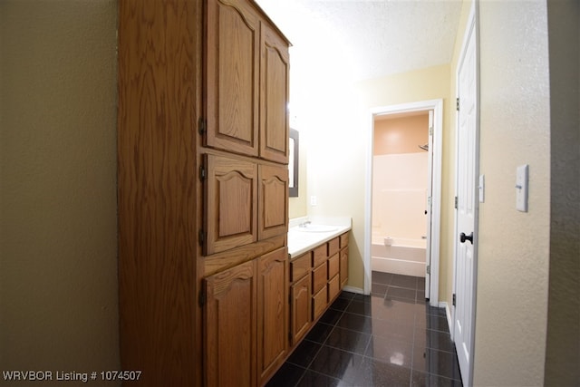 bathroom with vanity and a textured ceiling