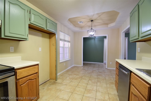 kitchen with pendant lighting, an inviting chandelier, green cabinetry, appliances with stainless steel finishes, and a tray ceiling