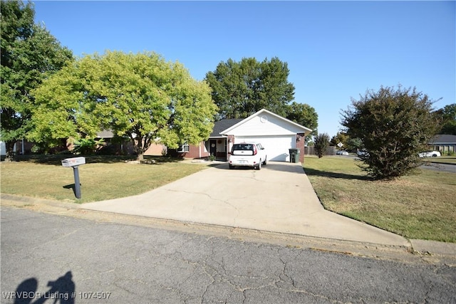 view of front of home featuring a front yard and a garage