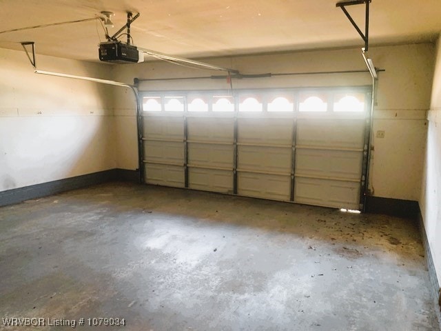 garage with a garage door opener and baseboards