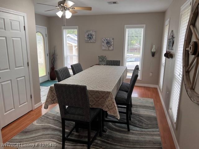 dining area featuring ceiling fan, light hardwood / wood-style floors, and a healthy amount of sunlight