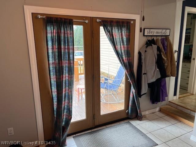 entryway featuring french doors and light tile patterned flooring