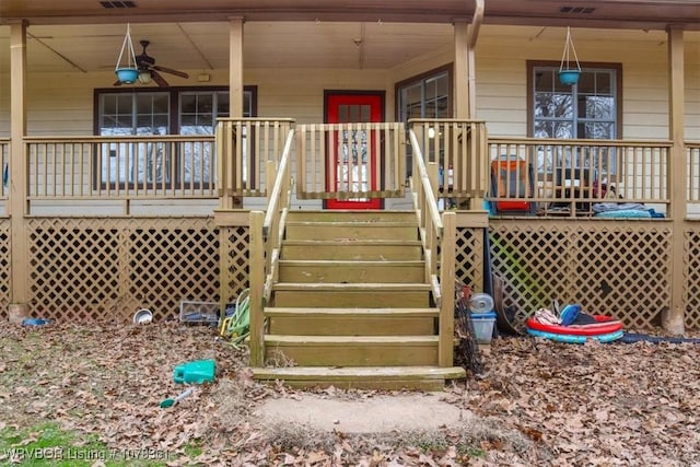 entrance to property featuring a porch and ceiling fan