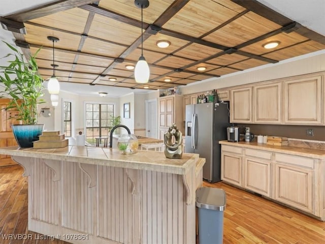 kitchen with a kitchen island with sink, stainless steel refrigerator with ice dispenser, decorative light fixtures, wooden ceiling, and light wood-type flooring