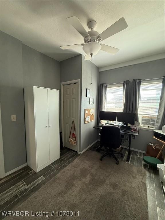 home office featuring dark hardwood / wood-style flooring and ceiling fan