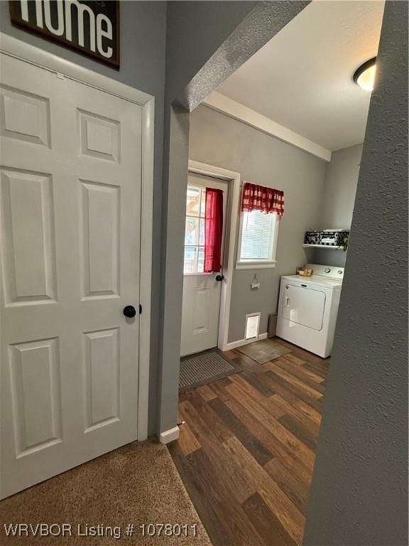 laundry room with washer / clothes dryer and dark wood-type flooring