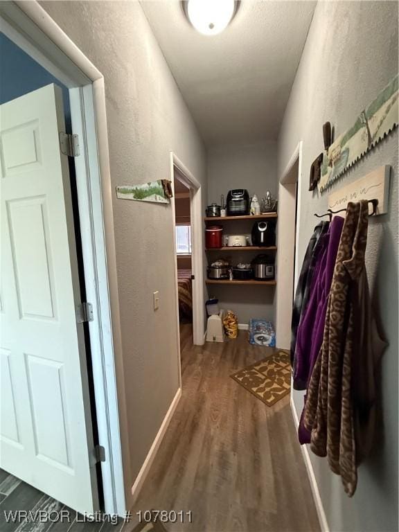 corridor with dark hardwood / wood-style flooring