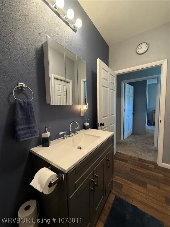 bathroom featuring hardwood / wood-style floors and vanity