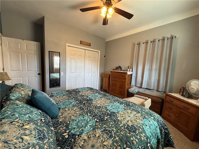 carpeted bedroom with ceiling fan, lofted ceiling, and a closet