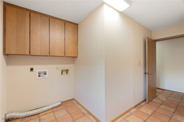 clothes washing area with cabinets, washer hookup, a textured ceiling, and electric dryer hookup