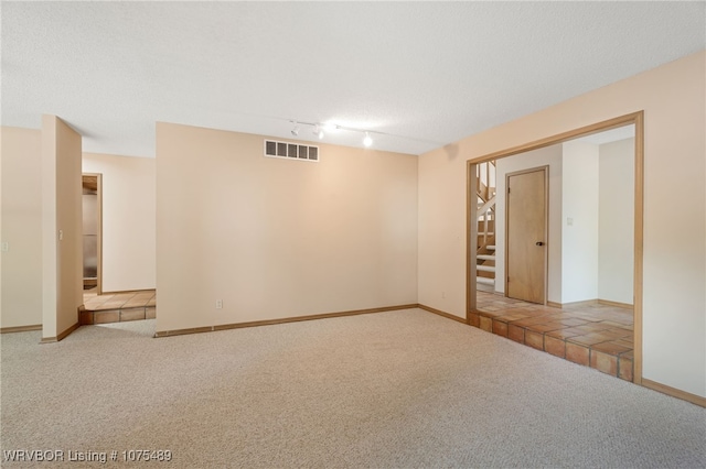 spare room with light carpet and track lighting