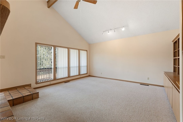 unfurnished living room featuring light carpet, beamed ceiling, ceiling fan, and high vaulted ceiling