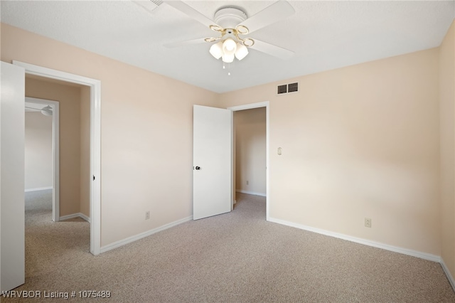 unfurnished bedroom featuring ceiling fan, light carpet, and a closet