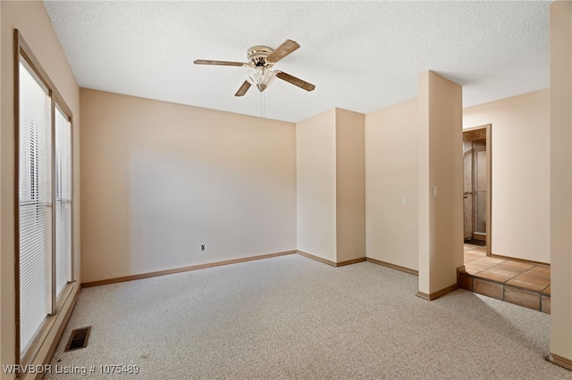 unfurnished bedroom featuring light carpet, a textured ceiling, a closet, and ceiling fan