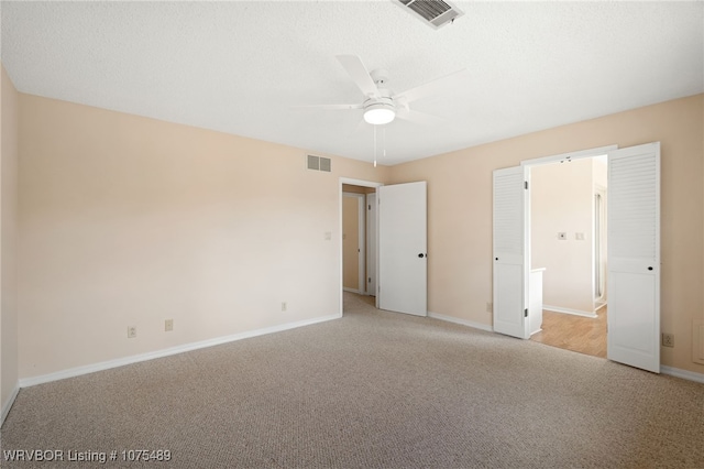 unfurnished bedroom with light carpet and ceiling fan