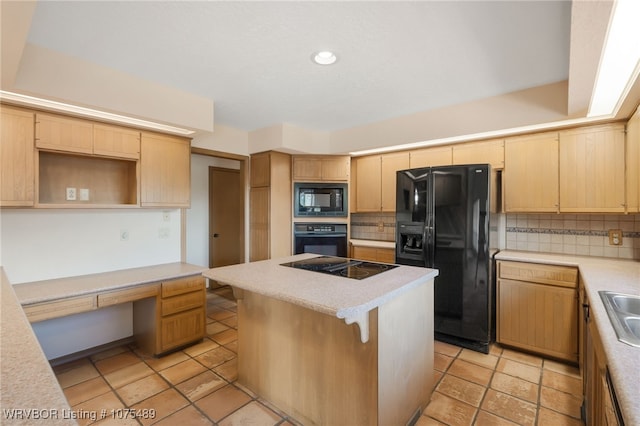 kitchen featuring a center island, light brown cabinets, tasteful backsplash, black appliances, and built in desk