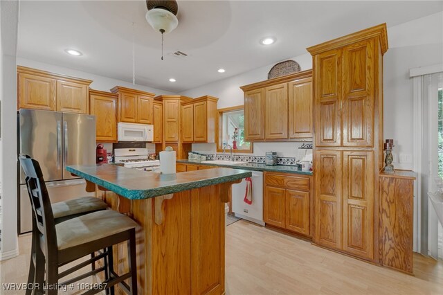 108498 4566th Rd, Sallisaw, OK 74955 - kitchen featuring white appliances, dark countertops, healthy amount of natural light, and recessed lighting