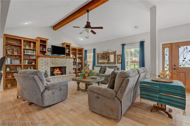 108498 4566th Rd, Sallisaw, OK 74955 - living room with light wood-type flooring, a brick fireplace, and a ceiling fan