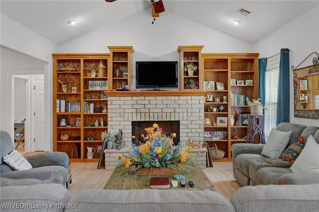 108498 4566th Rd, Sallisaw, OK 74955 - living area featuring wood finished floors, ceiling fan, vaulted ceiling, and a fireplace