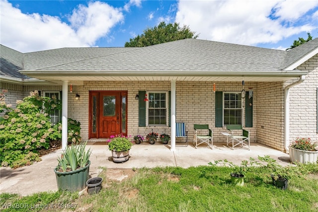 108498 4566th Rd, Sallisaw, OK 74955 - entrance to property with covered porch, a shingled roof, and brick siding