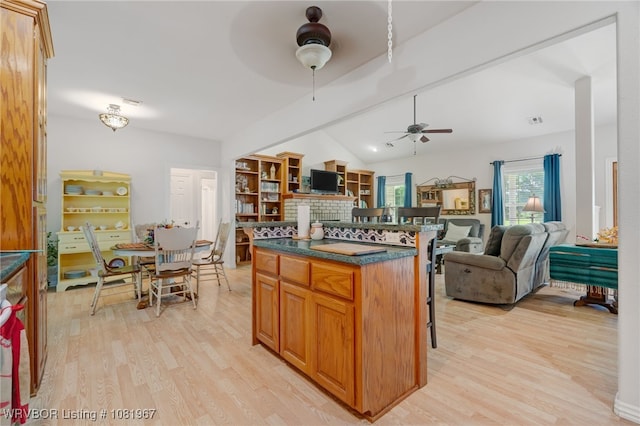 108498 4566th Rd, Sallisaw, OK 74955 - kitchen featuring ceiling fan, open floor plan, a fireplace, dark countertops, and vaulted ceiling