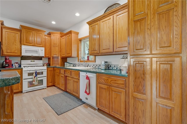 108498 4566th Rd, Sallisaw, OK 74955 - kitchen featuring white appliances, light wood-style floors, dark countertops, recessed lighting, and brown cabinetry