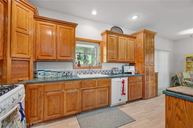 108498 4566th Rd, Sallisaw, OK 74955 - kitchen with white appliances, dark countertops, brown cabinetry, recessed lighting, and light wood finished floors