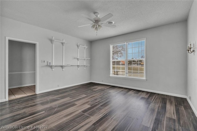 2101 N I St, Fort Smith, AR 72901 - unfurnished room with ceiling fan, wood finished floors, baseboards, and a textured ceiling