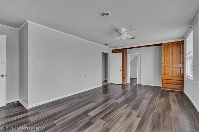 2101 N I St, Fort Smith, AR 72901 - unfurnished bedroom with dark wood-type flooring, baseboards, crown molding, and a ceiling fan