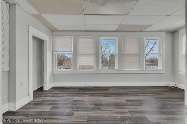 2101 N I St, Fort Smith, AR 72901 - empty room with a drop ceiling, wood finished floors, and baseboards