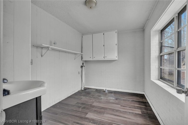 2101 N I St, Fort Smith, AR 72901 - laundry area with a textured ceiling and dark wood-type flooring