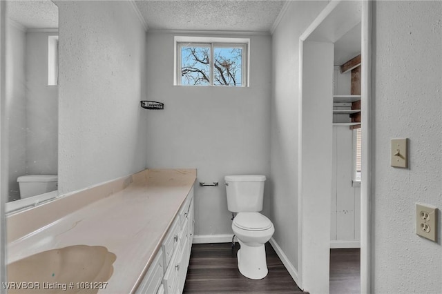 2101 N I St, Fort Smith, AR 72901 - bathroom featuring toilet, a textured ceiling, crown molding, wood finished floors, and baseboards